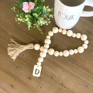 Hand-made and personalized wood garland with initial on tassel. Rustic farmhouse